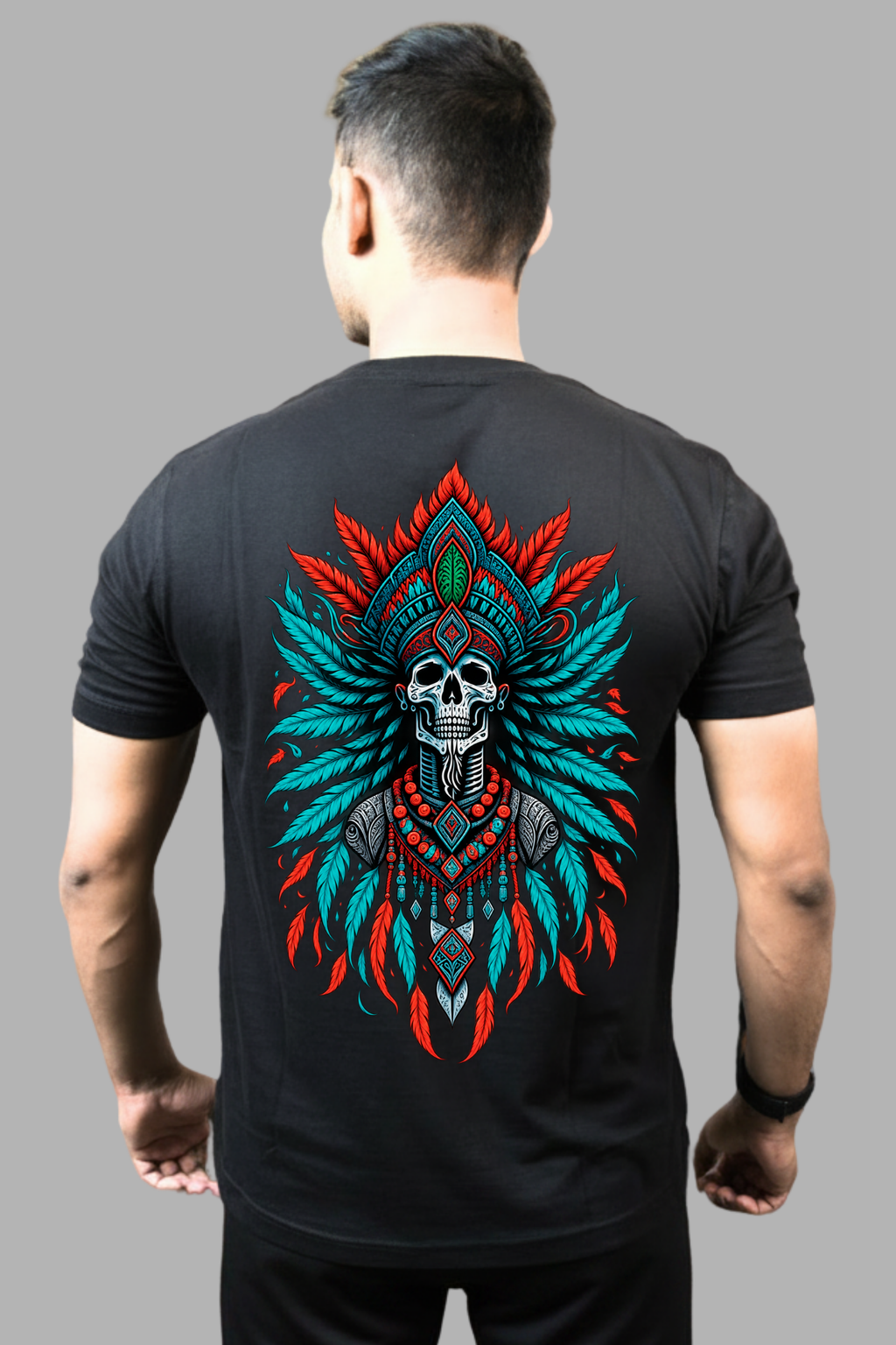 Man wearing a black regular-fit T-shirt with a red and teal tribal skull feather print on the back